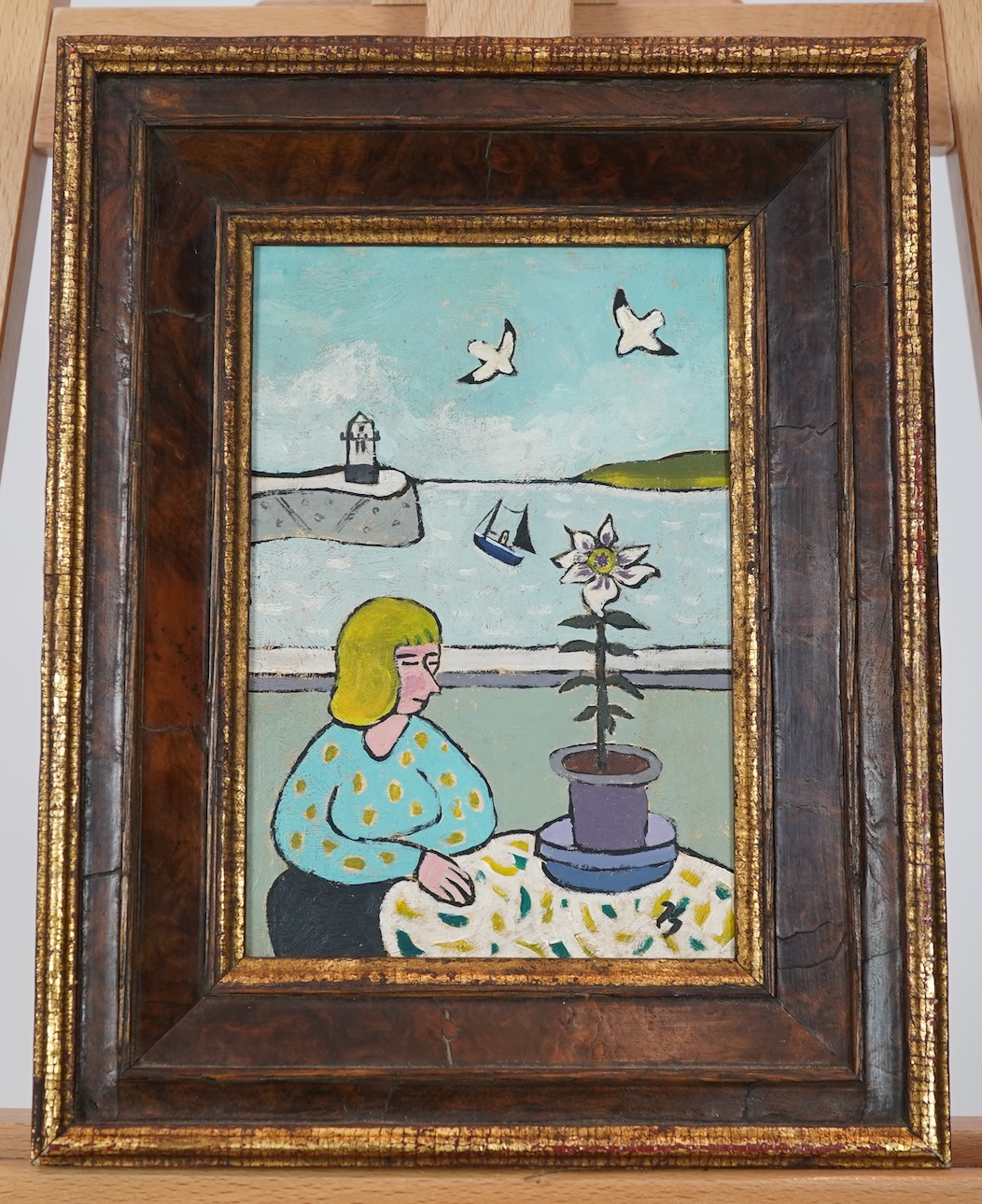 Joan Gilchrest, 1918-2008, A woman seated beside a table with a potted flower, a coastal view behind her